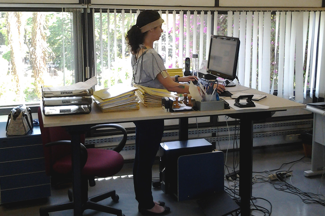 Adjustable sit-stand desk being used in a standing position